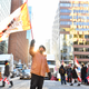 OTTAWA, ON - FEBRUARY 05: A protester holds a flag on Metcalfe Street on February 5, 2022 in Ottawa, Canada. Truckers continue their rally over the weekend near Parliament Hill in hopes of pressuring the government to roll back COVID-19 public health regulations and mandates.